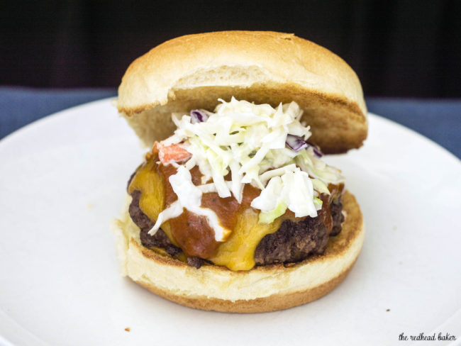 Carolina-style BBQ burgers are juicy beef patties topped with sharp cheddar cheese, tangy mustard- and vinegar-based BBQ sauce and coleslaw. #SundaySupper TheRedheadBaker.com