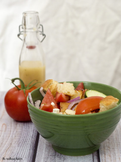 Greek Panzanella Salad is a perfect summer weeknight meal that combines tomato, red onion, cucumber, chicken and toasted bread with a homemade vinaigrette. The Redhead Baker.com