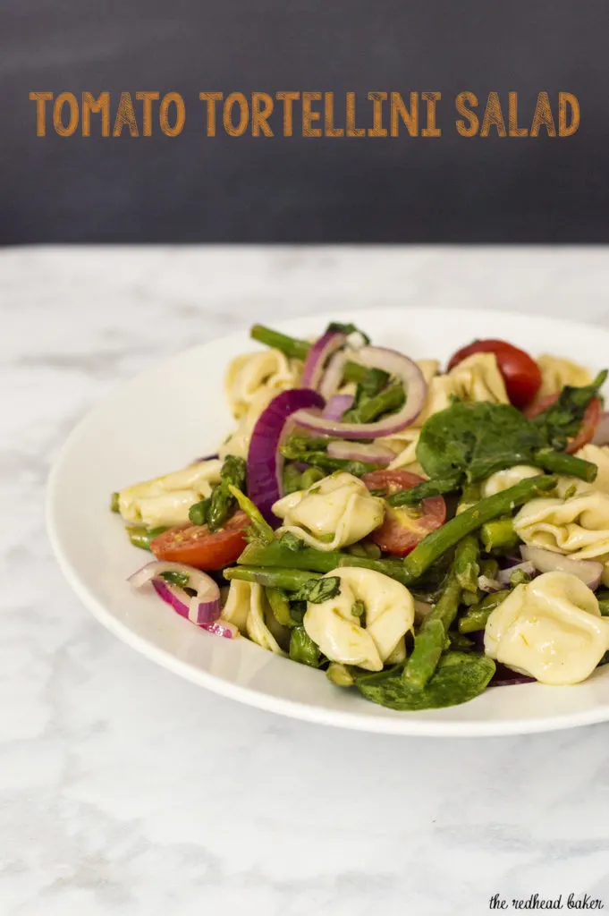 Tomato tortellini salad is my new favorite summer dinner! It combines lots of fresh, healthy vegetables, and comes together in under 30 minutes!