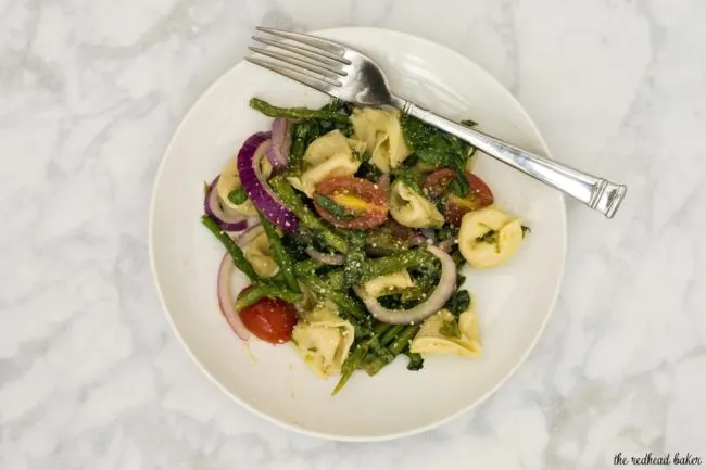 Tomato tortellini salad is my new favorite summer dinner! It combines lots of fresh, healthy vegetables, and comes together in under 30 minutes!