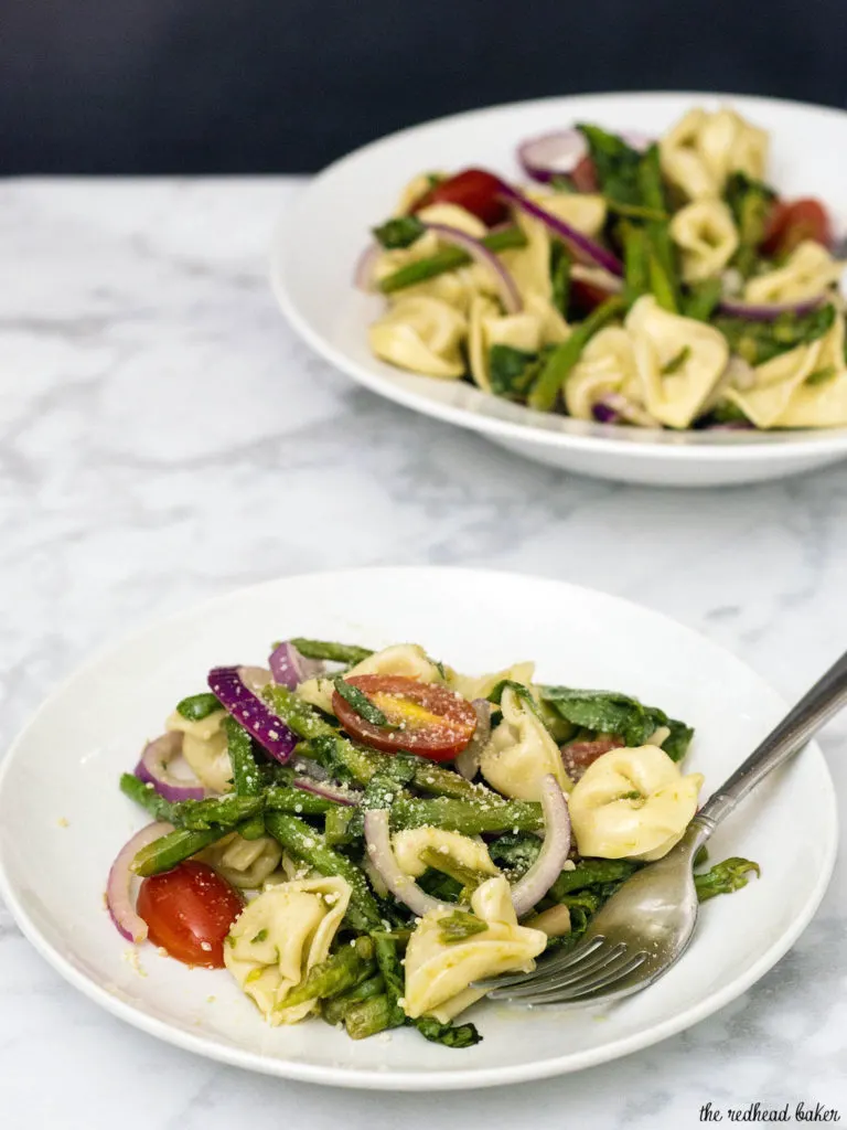 Tomato tortellini salad is my new favorite summer dinner! It combines lots of fresh, healthy vegetables, and comes together in under 30 minutes!