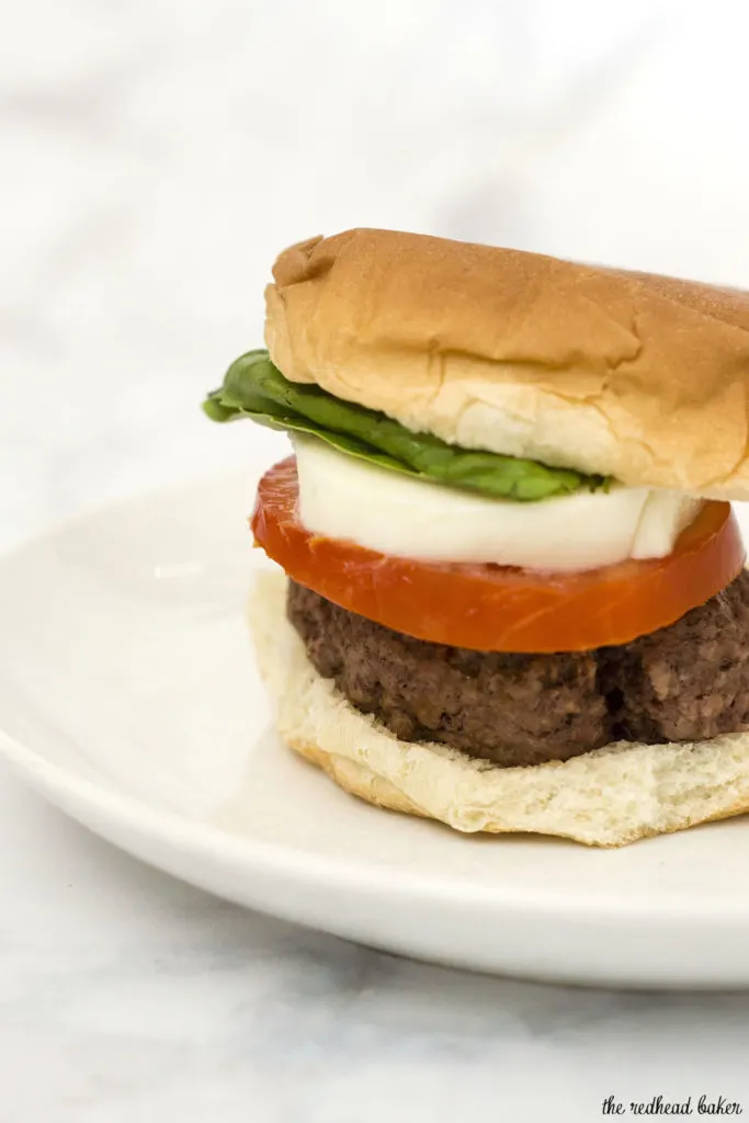 Caprese burgers are topped with the classic flavors of caprese — tomato, basil, mozzarella, and a balsamic reduction sauce. #SundaySupper