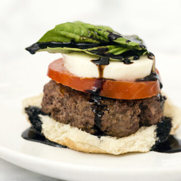 Caprese burgers are topped with the classic flavors of caprese — tomato, basil, mozzarella, and a balsamic reduction sauce. #SundaySupper