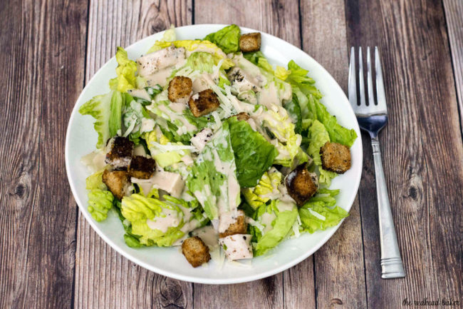 Lighter Caesar salad is delicious, and light on the calories. This version replaces most of the oil and the egg yolks in the dressing with fat-free Greek yogurt, making it creamy, but healthier.