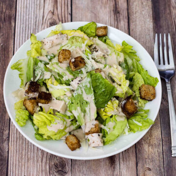 Lighter Caesar salad is delicious, and light on the calories. This version replaces most of the oil and the egg yolks in the dressing with fat-free Greek yogurt, making it creamy, but healthier.