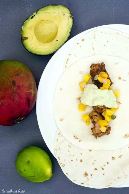 Mahi mahi tacos with mango salsa and avocado crema are a delicious, easy weeknight meal with lots of spice and summer flavor.