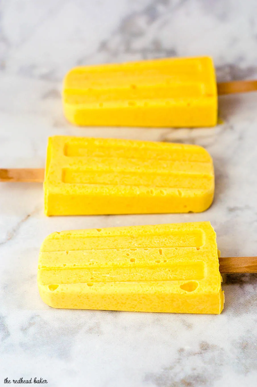 Mango creamsicles have only three ingredients, and are so easy to make! They're my son's favorite treat on a hot summer day. #SundaySupper