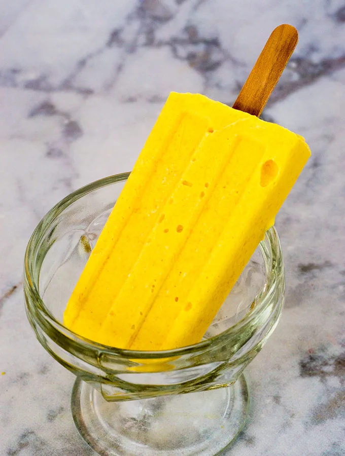 Mango creamsicles have only three ingredients, and are so easy to make! They're my son's favorite treat on a hot summer day. #SundaySupper