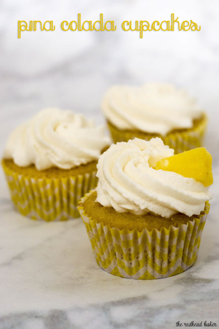 Pina colada cupcakes are soaked in rum syrup, filled with pineapple, and frosted with coconut whipped cream. A delicious summer treat! #SundaySupper