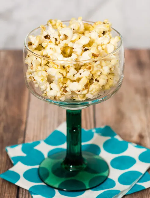 Indulge in an adult snack &mdash; margarita popcorn, coated in butter flavored with tequila and lime juice. It's so easy to make! #SundaySupper