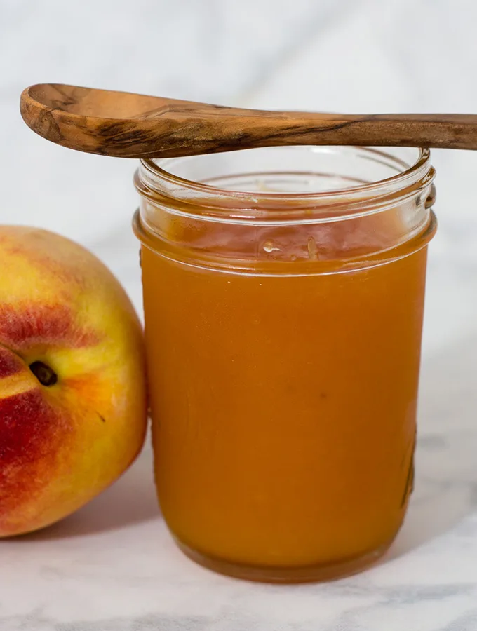 Peach butter is smoother and less sweet than peach preserves, resulting in a purer peach flavor. Canning peach butter preserves the flavor all year long. #SundaySupper