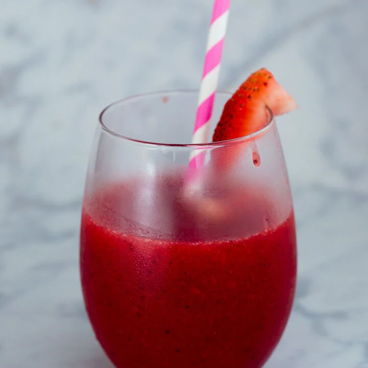 Strawberry sangria slushies are fun frozen cocktail — white wine blends with frozen strawberries and triple sec for a delicious summer treat!