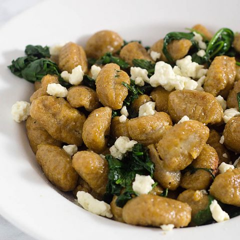 Pumpkin gnocchi and spinach with sage brown butter sauce is a hearty vegetarian meal full of flavor. You won't miss the meat! #SundaySupper