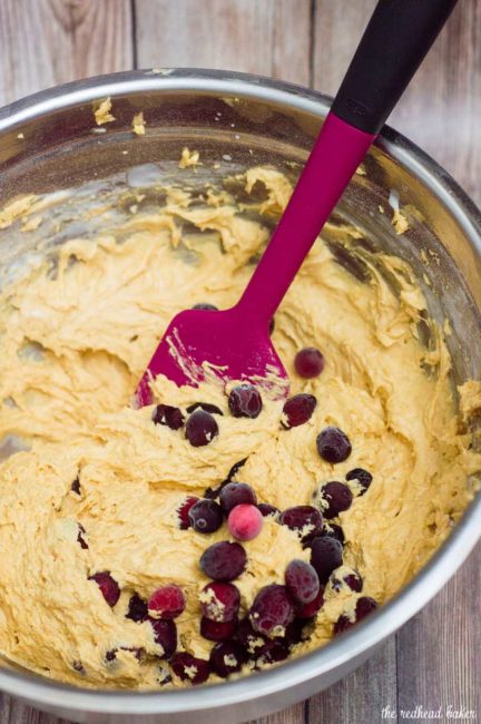 Two soft, light pumpkin cookies studded with fresh cranberries are sandwiched with creamy dulce de leche marshmallow filling.