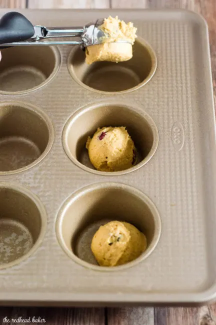 Two soft, light pumpkin cookies studded with fresh cranberries are sandwiched with creamy dulce de leche marshmallow filling.