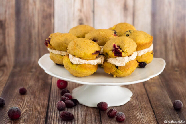 Two soft, light pumpkin cookies studded with fresh cranberries are sandwiched with creamy dulce de leche marshmallow filling.