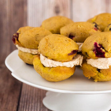 I liked these big pumpkin-spice cookies when I first made them and thought of them as cookies. But when I sandwiched them with a marshmallow crème and dulce de leche filling, officially turning them into whoopie pies, “like” became too mild a word for how I felt about them. They passed over into love ’em territory, and they’ve stayed there ever since. The cookies themselves have the soft, light texture and flavor of spice cake. In fact, they’d be exactly like spice cake if they didn’t have the surprise of fresh cranberries, which, in addition to adding color and pop, have just the right the amount of pucker to make the sweet a grown-up dessert. As for the filling, sticky, sweet fluff is a must. It’s just about part of the definition of whoopie pies. For these, it’s paired with store-bought or homemade dulce de leche. It’s the perfect combo, but when you’re ready for a swap, sandwich the cookies with a spiced cream cheese filling.