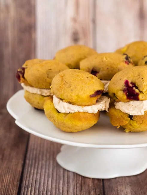 I liked these big pumpkin-spice cookies when I first made them and thought of them as cookies. But when I sandwiched them with a marshmallow crème and dulce de leche filling, officially turning them into whoopie pies, “like” became too mild a word for how I felt about them. They passed over into love ’em territory, and they’ve stayed there ever since. The cookies themselves have the soft, light texture and flavor of spice cake. In fact, they’d be exactly like spice cake if they didn’t have the surprise of fresh cranberries, which, in addition to adding color and pop, have just the right the amount of pucker to make the sweet a grown-up dessert. As for the filling, sticky, sweet fluff is a must. It’s just about part of the definition of whoopie pies. For these, it’s paired with store-bought or homemade dulce de leche. It’s the perfect combo, but when you’re ready for a swap, sandwich the cookies with a spiced cream cheese filling.
