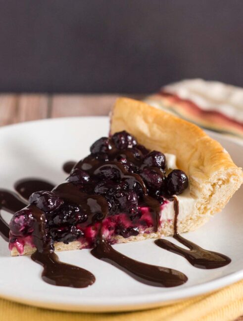 Pizza for dessert? You bet! Cheesecake Pizza has crescent dough as the crust, topped with sweetened cream cheese, berry compote and chocolate sauce. #SundaySupper