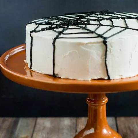 Scare up some fun with this spooky Halloween Spiderweb Cake. It involves basic piping techniques, so it's easy enough for beginner cake decorators!