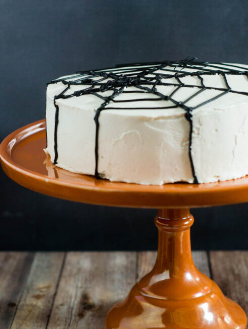 Scare up some fun with this spooky Halloween Spiderweb Cake. It involves basic piping techniques, so it's easy enough for beginner cake decorators!