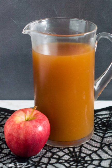 Serve a spooky witch's brew at your Halloween party — a Poison Apple Cider Cocktail, with rum and cinnamon-infused brandy!