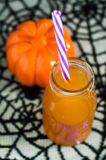 Serve a spooky witch's brew at your Halloween party — a Poison Apple Cider Cocktail, with rum and cinnamon-infused brandy!