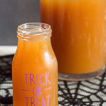 Serve a spooky witch's brew at your Halloween party — a Poison Apple Cider Cocktail, with rum and cinnamon-infused brandy!