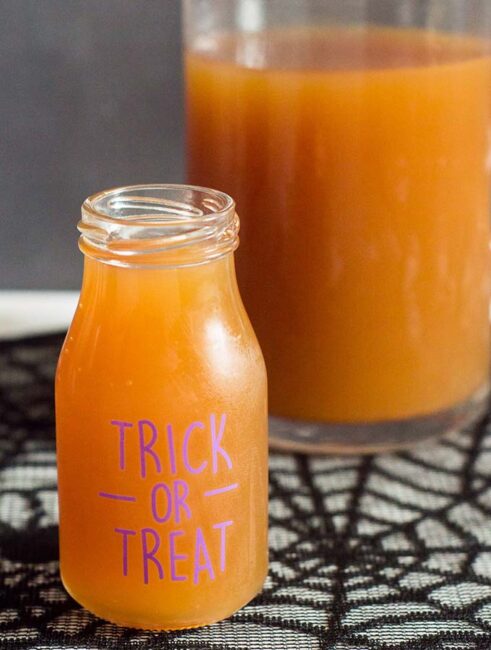 Serve a spooky witch's brew at your Halloween party — a Poison Apple Cider Cocktail, with rum and cinnamon-infused brandy!