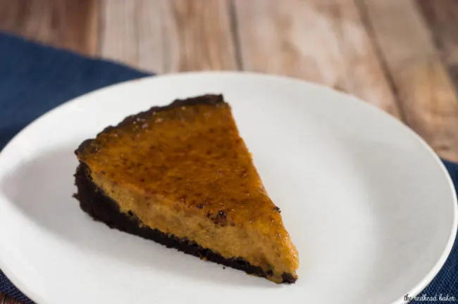 Move over, classic pumpkin pie! Pumpkin brulee tart has a custard-like spiced pumpkin filling baked in a chocolate cookie tart shell, then is sprinkled with sugar and bruleed. #PumpkinWeek