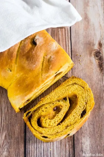 Comfort food with a fall twist &mdash; pumpkin cinnamon raisin bread is studded with raisins with a swirl of cinnamon, butter and brown sugar. #PumpkinWeek