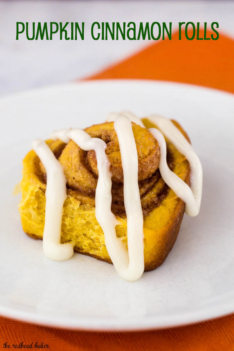 Pumpkin cinnamon rolls are a delicious way to start a fall morning! Sweet dough is flavored with pumpkin, rolled with a cinnamon filling, and topped with cream cheese drizzle. #PumpkinWeek