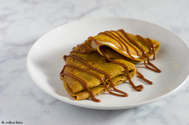 Pumpkin crepes are very thin dessert pancakes, folded over sweetened cream cheese filling and drizzled with dulce de leche. #PumpkinWeek