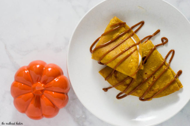 Pumpkin crepes are very thin dessert pancakes, folded over sweetened cream cheese filling and drizzled with dulce de leche. #PumpkinWeek