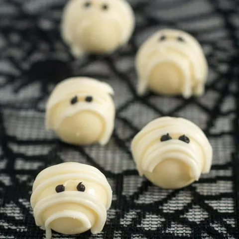 Boo! Scare your Halloween dinner or party guests with these easy-to-make white chocolate mummy truffles made with white chocolate ganache! #ProgressiveEats