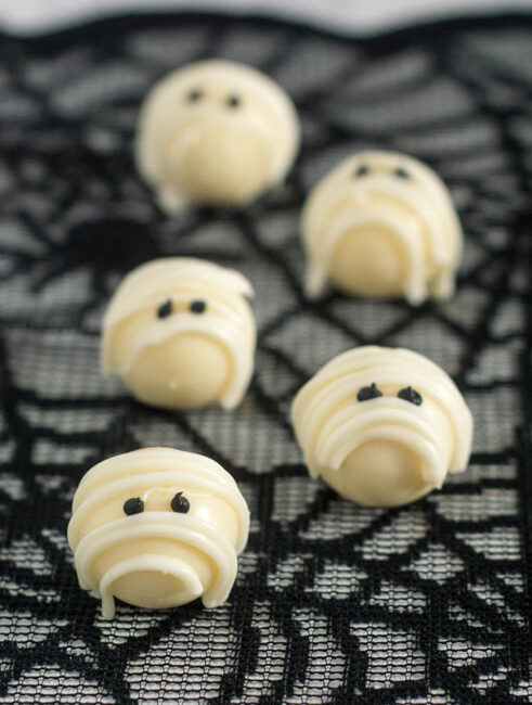 Boo! Scare your Halloween dinner or party guests with these easy-to-make white chocolate mummy truffles made with white chocolate ganache! #ProgressiveEats