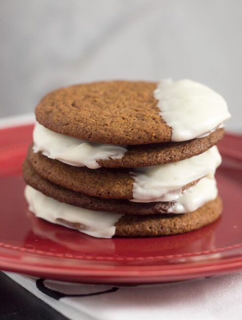 Warmly spiced gingerbread cookies get fancy for the holidays with a dip in white chocolate. Santa will love getting these cookies on Christmas Eve!