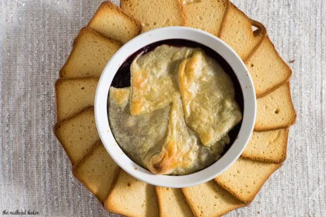 Baked brie en croute is a luxurious appetizer, and this one goes the extra mile with a flavorful cabernet cranberry cherry sauce. #ProgressiveEats