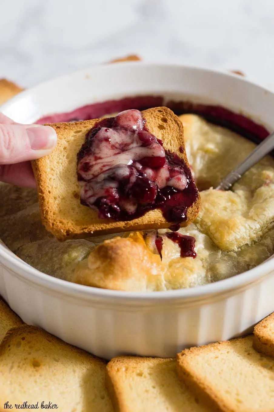 Baked brie en croute is a luxurious appetizer, and this one goes the extra mile with a flavorful cabernet cranberry cherry sauce. #ProgressiveEats