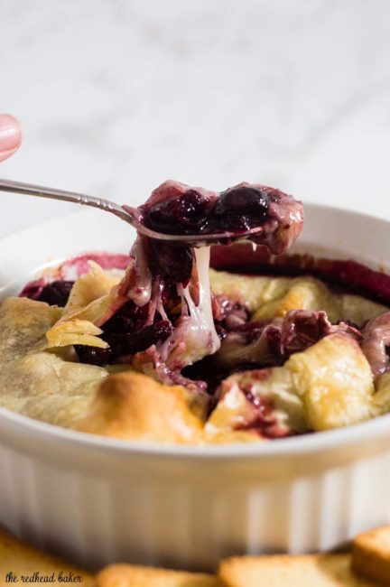 Baked brie en croute is a luxurious appetizer, and this one goes the extra mile with a flavorful cabernet cranberry cherry sauce. #ProgressiveEats