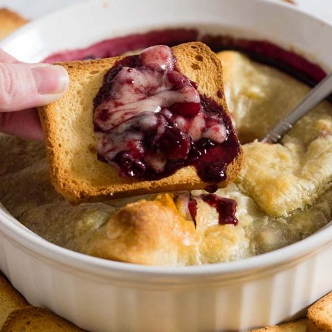 Baked brie en croute is a luxurious appetizer, and this one goes the extra mile with a flavorful cabernet cranberry cherry sauce. #ProgressiveEats