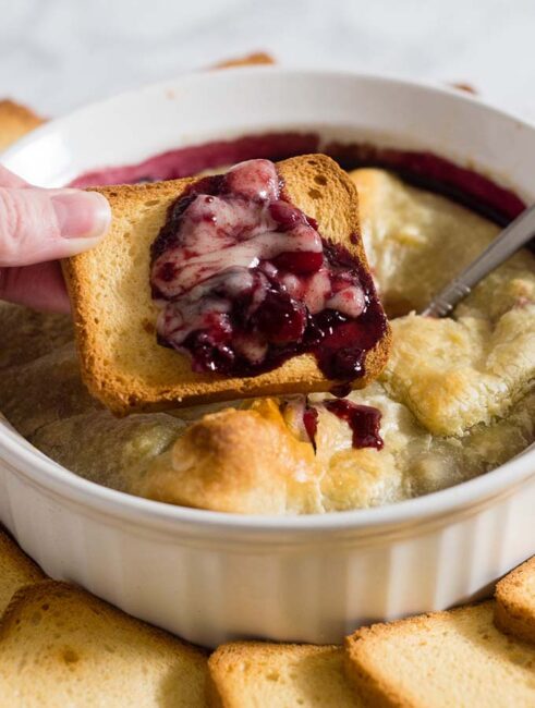 Baked brie en croute is a luxurious appetizer, and this one goes the extra mile with a flavorful cabernet cranberry cherry sauce. #ProgressiveEats