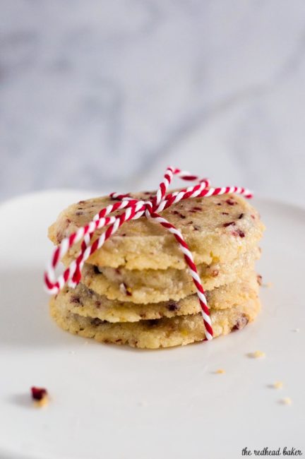 Shortbread cookies are a Scottish Christmas tradition. This version of the crumbly cookie is flavored with dried cranberries and orange zest. #IntnlCookies