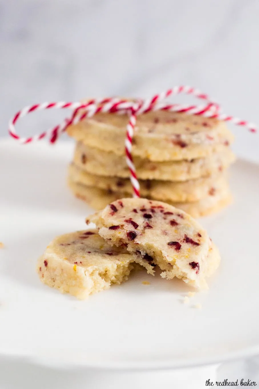 Shortbread cookies are a Scottish Christmas tradition. This version of the crumbly cookie is flavored with dried cranberries and orange zest. #IntnlCookies