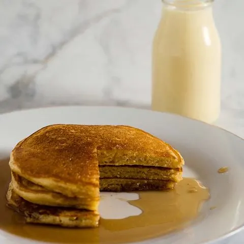 Eggnog pancakes are light and fluffy with the subtle flavor of the traditional Christmas drink, drizzled with nutmeg-infused maple syrup.