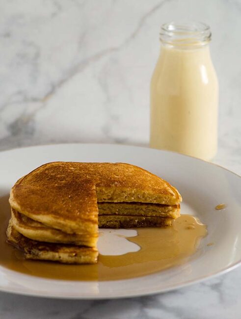Eggnog pancakes are light and fluffy with the subtle flavor of the traditional Christmas drink, drizzled with nutmeg-infused maple syrup.