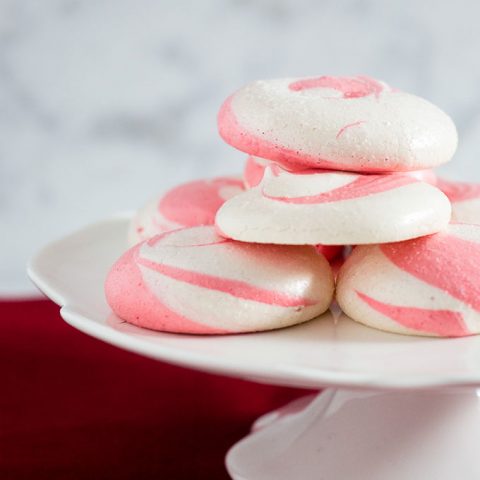 Beautiful swirled peppermint meringue cookies are a festive addition to your holiday party dessert tray! Bonus: they're naturally fat-free! #SundaySupper