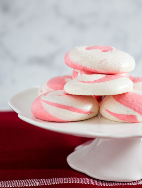 Beautiful swirled peppermint meringue cookies are a festive addition to your holiday party dessert tray! Bonus: they're naturally fat-free! #SundaySupper