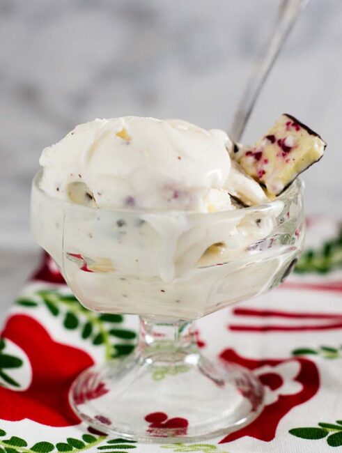 Rich white chocolate peppermint bark ice cream is a delicious holiday treat, with bits of the popular Christmas treat mixed throughout the ice cream.