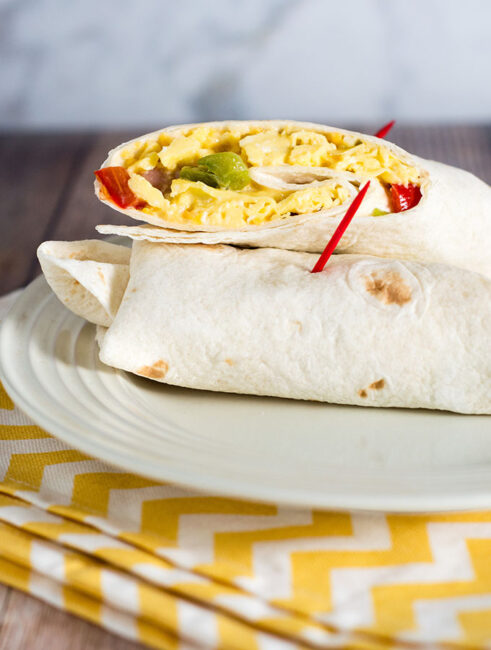 Customize these freezer-friendly egg and cheese breakfast burritos however you like. In the morning, just unwrap, reheat and go!